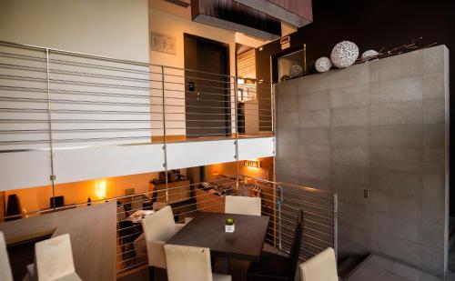 a dining room with a table and white chairs at Ex-L in Fiume Veneto