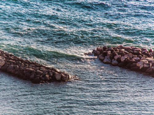 a group of rocks in a body of water at Maison del sole in Massa Lubrense