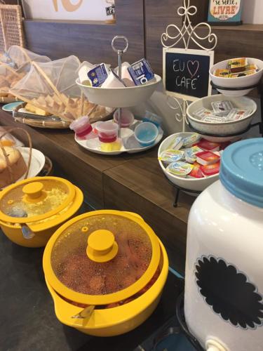 a display of food in bowls and plates on a table at Pousada Villa Atlântica in Balneário Camboriú