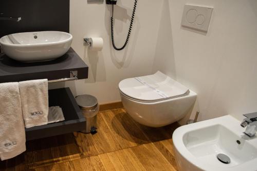 a bathroom with a white toilet and a sink at Ex-L in Fiume Veneto