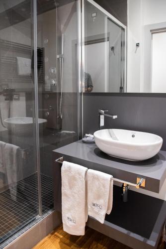 a bathroom with a sink and a glass shower at Ex-L in Fiume Veneto
