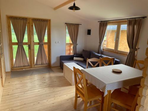 a living room with a table and a couch at JZ Guest Ranch in Woldenberg Neumark