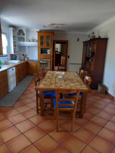 a kitchen with a wooden table and chairs at Casa Da Bela Vista in Viana do Castelo