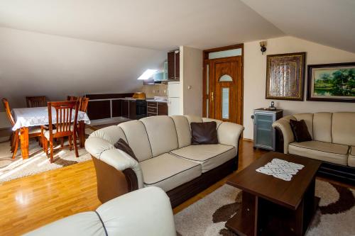 a living room with a couch and a table at Apartments Ratković in Tivat