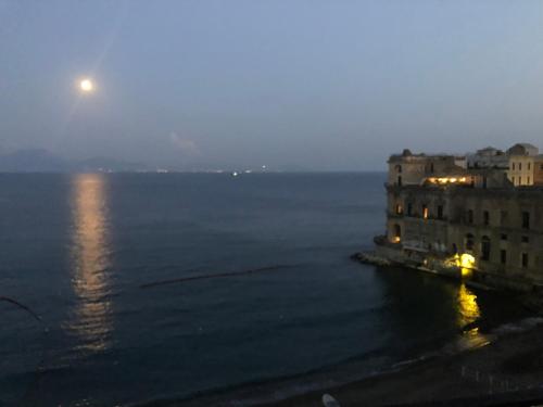 a view of the ocean at night with a full moon at B&B Vista Mare in Naples