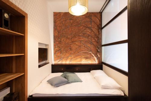 a small bed with two pillows in a room at Krakowhomes in Kraków
