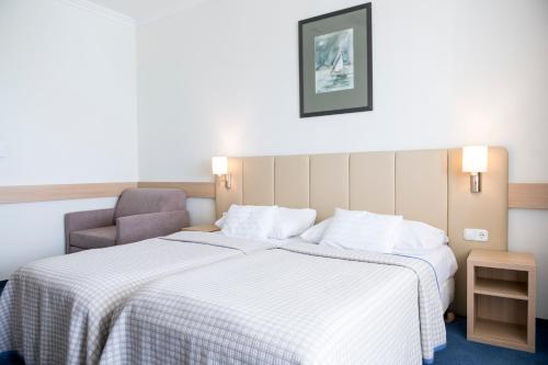 Postel nebo postele na pokoji v ubytování Hotel Marina Port