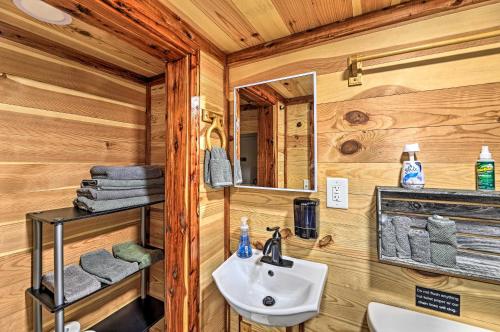a bathroom with a sink and a mirror at The Gosling Studio Cabin with River Access! in New Bern