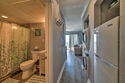 a bathroom with a toilet and a refrigerator at Oceanfront Corpus Christi Condo Resort Perks! in Corpus Christi