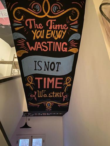 a sign that says the time you enjoy wasting is not time at Hostel La Smala in Essaouira