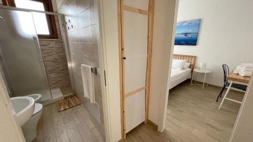 a bathroom with a shower and a toilet and a sink at Casa Stella in Favignana