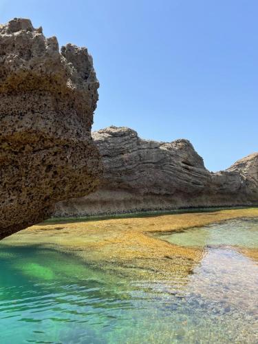 a body of water next to some rocks at Zohara boutiqe suite in Caesarea