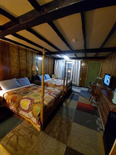 a bedroom with a bed and a television in it at Pocono mountain hotel and spa in Gouldsboro