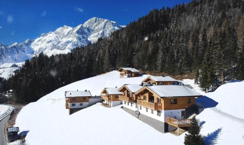a house on top of a snow covered mountain at Skyberg Chalet in Mühlbach am Hochkönig
