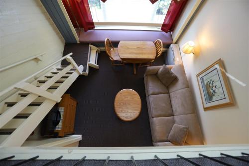 an overhead view of a staircase with a table and a chair at Inns Of Wv 405, 1bd, Waterville Valley in Waterville Valley
