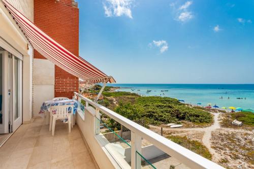 a balcony with a view of the beach at Appartamento fronte mare - Waterfront apartment in Putzu Idu