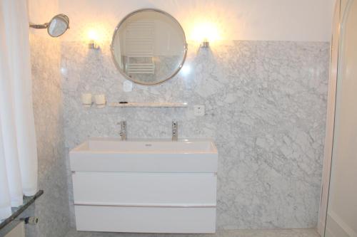 a bathroom with a sink and a mirror at Barony Le Pergole holiday apartments Lugano in Lugano