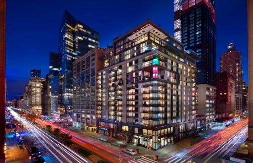 a tall building in a city at night at Royalton Park Avenue in New York