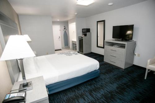 a hotel room with a bed and a flat screen tv at Anchor Beach Inn in Crescent City