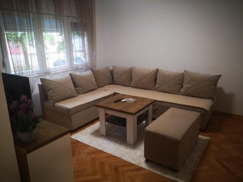 a living room with a couch and a coffee table at Apartman Olga in Trebinje