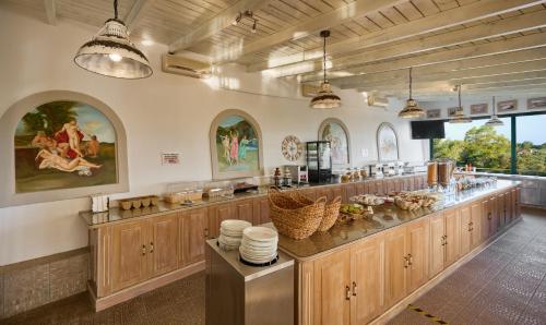 eine große Küche mit Holzschränken und einer Arbeitsplatte in der Unterkunft Kastro Maistro in Lefkada Town