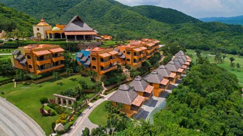 an aerial view of a resort with mountains in the background at El Corazón Golf & Spa Resort Manzanillo in Manzanillo