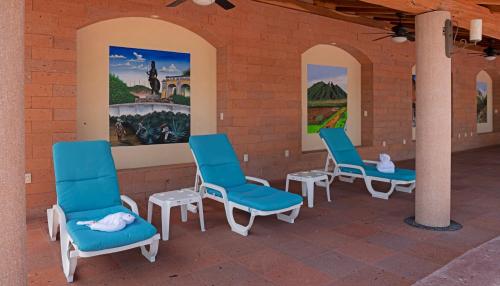 a group of blue chairs sitting on a brick wall at El Corazón Golf & Spa Resort Manzanillo in Manzanillo