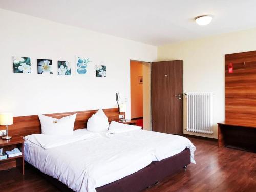 Postel nebo postele na pokoji v ubytování Gartenhotel LandArt