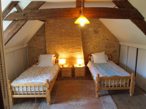 Postel nebo postele na pokoji v ubytování La Ferme de Grand Jean