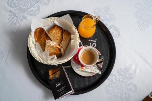 a black plate with a basket of bread and a cup of coffee at Mercure Medias Binderbubi Hotel And Spa in Mediaş