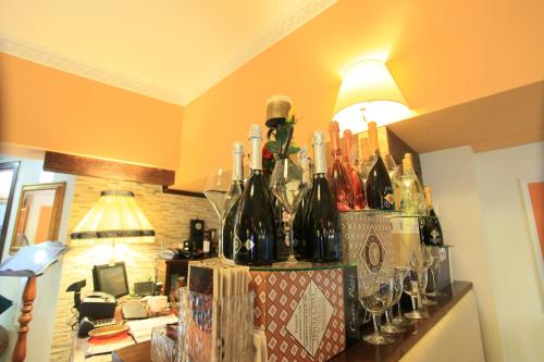 a bunch of wine bottles and glasses on a counter at Balconata 2.0 Banqueting & Accommodations in Lucera