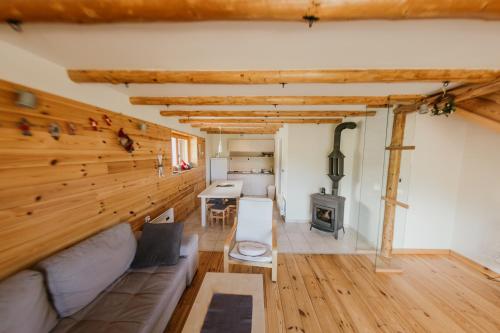 a living room with a couch and a stove at Holiday Home Elena in Kopaonik