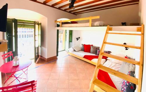 a room with two bunk beds and a table at Hostel Plaza Mayor Corredera in Córdoba