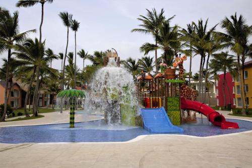a pool filled with water and a person jumping in it at Tropical Deluxe Princess - All Inclusive in Punta Cana