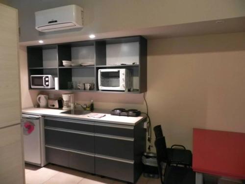 a small kitchen with a sink and a microwave at Alugar in Valeria del Mar