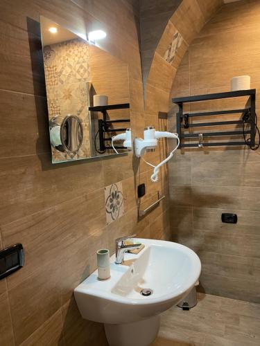 a bathroom with a white sink and a mirror at L’angolo delle bugie in Turi