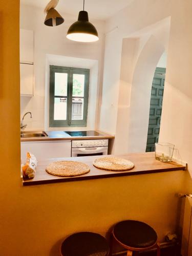 a kitchen with two stools sitting on a counter at LA MALINCHE in Segovia
