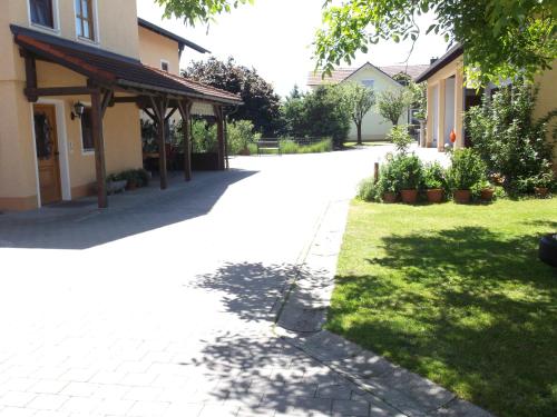 a walkway in front of a house with a yard at Appartementhaus Panny in Bad Füssing
