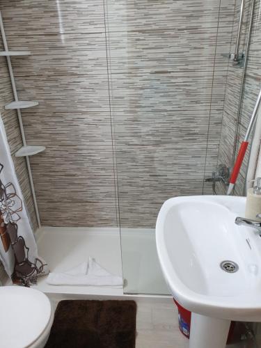 a bathroom with a sink and a shower at Cozy apartment near the ocean in Corralejo