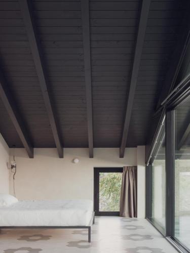 a bedroom with a bed and a window at Agriturismo Olmo in Sondrio