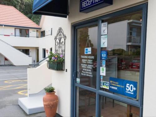 a store front with a sign on the door at Bella Vista Motel Wellington in Wellington