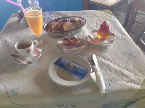 a table with a breakfast of coffee and food on it at Samaria in Agia Roumeli