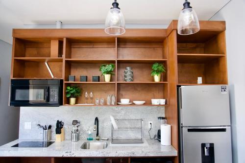 a kitchen with a sink and a refrigerator at Rio Suites in Tijuana