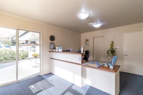 an office with a reception counter and a window at Admirals Motor Inn in Nelson