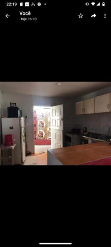 a kitchen with a refrigerator and an open door at Casa Jeri in Jericoacoara