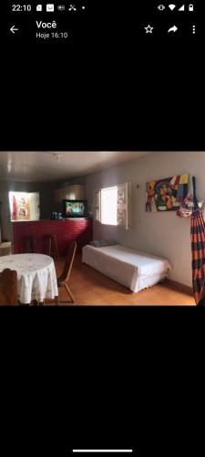a room with a bed and a table with a table at Casa Jeri in Jericoacoara