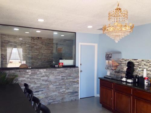 a dining room with a chandelier and a bar at Sanger Inn in Sanger