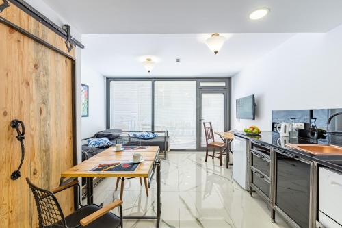 a kitchen and living room with a table and chairs at Villa Pera Suite Hotel in Istanbul