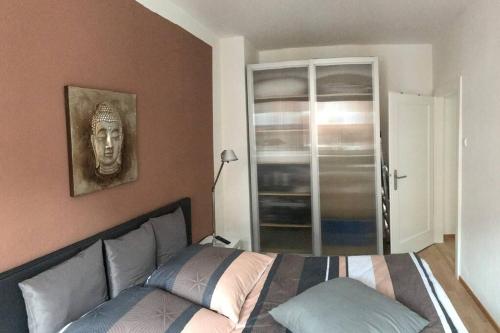 a bedroom with a bed and a picture of a head at Trade fair and business apartment - Hannover Messe in Hannover