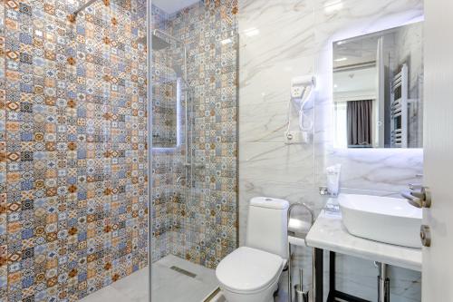 a bathroom with a toilet and a sink at Monument1880 in Tbilisi City